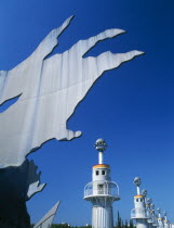 Parc Espanya Industrial.  Abstract sculpture in foreground  line of towers with balconies encircling them.