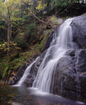 Moss Glen Falls.  Waterfall over steep rockface in wooded area.