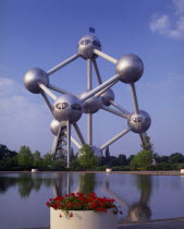 The Atomium.  Vast structure of connecting metal spheres reflected in lake in the foreground.