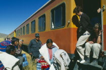 Train stopped at the altiplano on the highest pass on the line between Puno to Cusco  passengers disembarking.