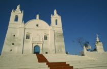 Church of St Thomas. Exterior view looking up red painted steps toward facade