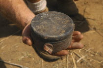 Man holding Russian Made Anti Personnel Mine.