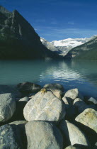 Lake Louise with chipmunk on rock in foreground.