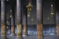 The Church Of The Nativity limestone pillars with candle holders hanging down between them