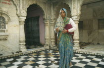 Rat Temple with woman worshiper in traditional dress