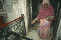 Rat Temple with woman in traditional dress feeding the rats