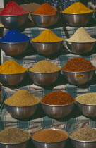 Bowls of herbs and spices on market stall