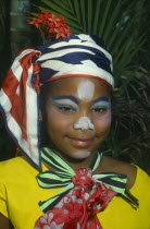 Head and shoulders portrait of girl in costume and face paint.