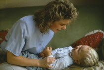 Mother playing with young son.