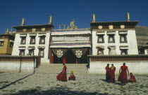 Tibetan Monastery with monks gathered outside