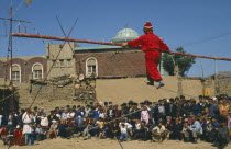 Acrobat Troupe performing tight rope walking in the street