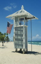 Lifeguard post on beach with American Stars and Stripes flag.