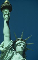 Cropped shot of Statue of Liberty detailing head and raised arm.