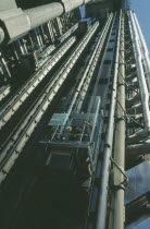 View looking up at the lifts with pasengers on the exterior of the Lloyds building