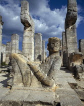 Mayan ruins with statue of reclining man and columns