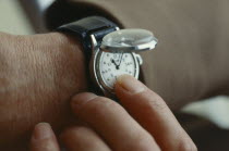 Close up of hand reading Braille Watch