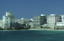 View towards fort and old waterfront buildings from the sea.