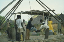 Collecting water at well sunk by International Voluntary Service.IVS  aid