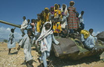 Children playing on rusting tank on road between Asmara and Keren near Aderde.