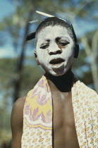 Portrait of young girl with her face covered in ritual whitening for initiation ceremony held after her first menstruation.