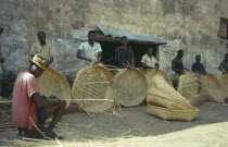 Men weaving baskets used for coffee.