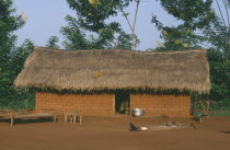 Typical roadside dwelling of the Sango Tribe with mud brick walls and thatched roof.