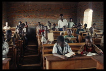 Azande children sitting at wooden desks in school classroom.Zande Zaire