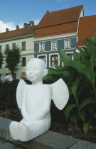 Moveable angel statue with typical buildings behind.