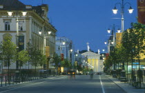 Gedimino shopping street lined with illuminated street lights leading to the Cathedral at night.