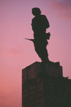 Plaza de la Revolution.  Statue of Che Guevara silhouetted at sunset.