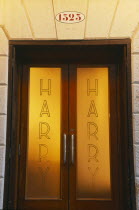 Door of Harry s Bar with name etched on the frosted glass.