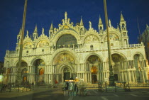 Basilica di San Marco exterior facade at night with clothing stall in square in the foregroundSt Mark