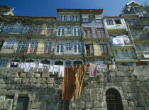 Washing hanging from walls and balconies of waterfront houses in the Ribeira riverside quarter.