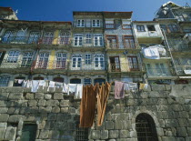 Washing hanging from walls and balconies of waterfront houses in the Ribeira riverside quarter.