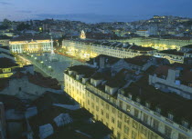 Baixa.  Praca dom Pedro IV at night with illuminated buildings and light trails from passing traffic.