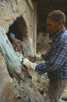 Chouwara Tanneries.  Stripping fleece from skins before dyeing.Fez