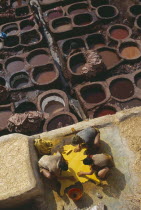 Chouwara Tanneries.  Men working at the tanner s pits with coloured dyes.Colored Fez