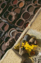Chouwara Tanneries.  Men working at the tanner s pits with coloured dyes.Colored Fez
