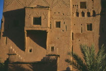 Kasbah Taorirt .  Nineteenth century kasbah of the el-Glaoui dynasty.  Detail of exterior wall with simple decoration and small windows with metal screens.