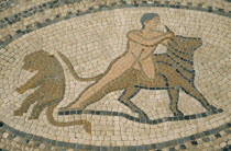 Detail of mosaic depicting man wrestling bull.