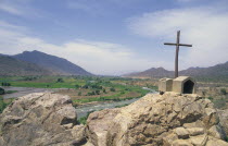 Road side cross  with river and flood plain in back-ground on road from Cajamarca to Chiclayo.