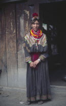 Kalash woman standing  wearing traditional dress.