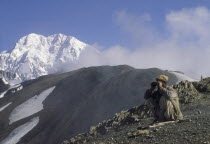 Hill tribe hunter  with Tirich Mir in the background.Asia Asian Pakistani Scenic Northern One individual Solo Lone Solitary