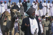 Omani sheikh with prize camel at the end of 50km race  receiving prize.