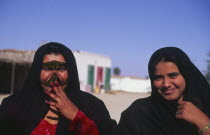 Bedu women  including one wearing traditional face mask.