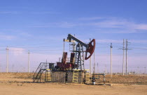 Oil derrick and lots of power lines in the background.