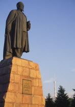Statue of Lenin  with telecommunications tower in background.