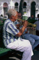 Man playing trumpet in the Plaza Central.