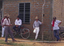 A group of Llanero men standing next to a building  Orocue