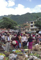 A busy Saturday market  people buying fruit and vegetables.
